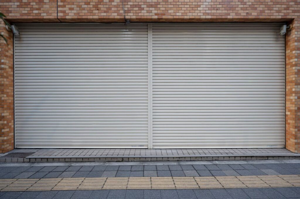 Closed Rolling Steel Garage Doors – Maintenance Ready in Los Angeles Two closed rolling steel garage doors on a commercial building, ideal for maintenance service